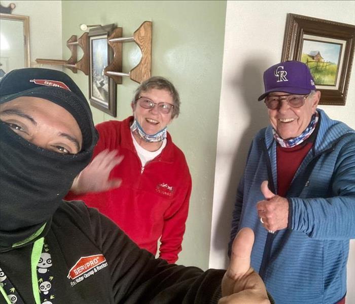 Our technician with an older couple in Boulder smiling with thumbs up